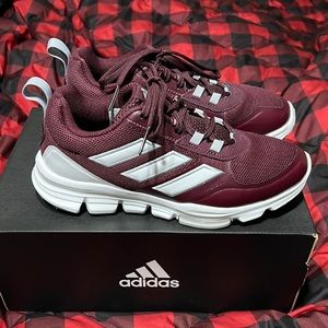 Maroon and white Adidas shoes